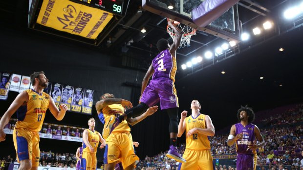 Flying high: Kendrick Perry dunks on the Adelaide 36ers.