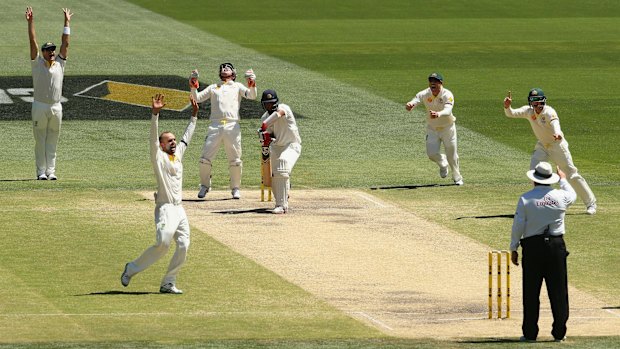 Got him this time: Nathan Lyon picks up the wicket of Cheteshwar Pujara.