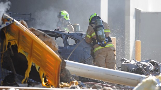Emergency services personnel work at the  crash scene.