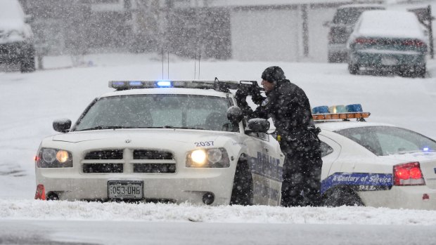An officer ready to shoot after reports of a shooting near a Planned Parenthood clinic in Colorado Springs on Friday. 