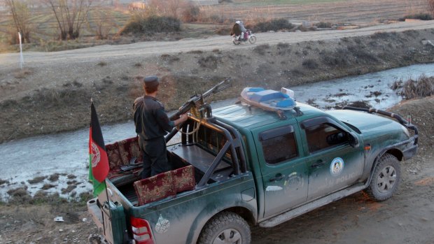 Afghan police patrol in Lashkar Gah on Monday.