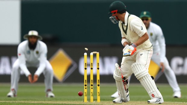 David Warner is bowled by Kyle Abbott of South Africa during day three of the Second Test between Australia and South Africa at Blundstone Arena.