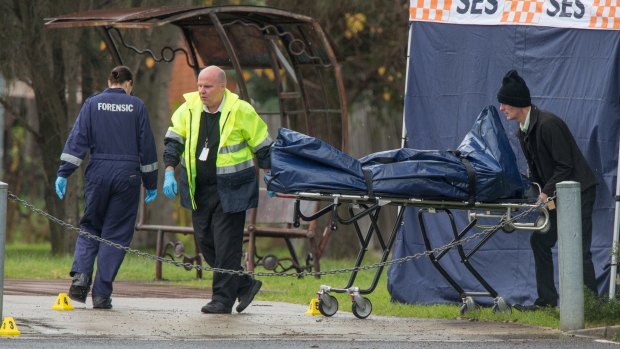 A body is removed from the scene at Dunstan Reserve in West Brunswick.