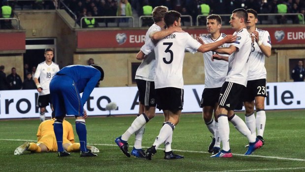 Great start: German players celebrate with Andre Schuerrle after the opening goal of the contest.