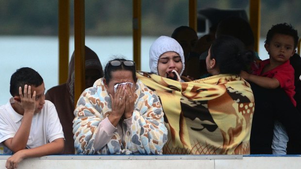 People who survived the capsizing of a ferry wait for more information about their missing friends and relatives.