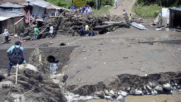 People look into the rubble after the landslide in Salgar municipality, Colombia on Monday.