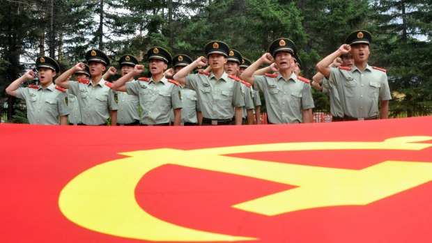 Chinese paramilitary policemen pledge loyalty to the Communist Party as they observe the 94th anniversary of the founding of the Communist Party of China on July 1. 