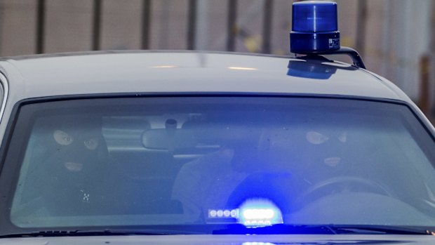 A police car believed to be transporting terror suspect Salah Abdeslam leaves the prison in Bruges, Belgium, on Thursday.