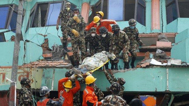 Nepalese and Indian rescue teams remove a body from the collapsed Sitapyla church in Kathmandu, Nepal on Monday.