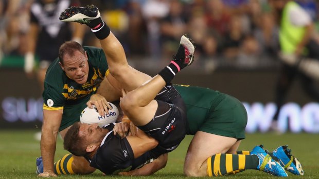 Upside down: Kiwis hooker Lewis Brown is tackled by the Kangaroos.