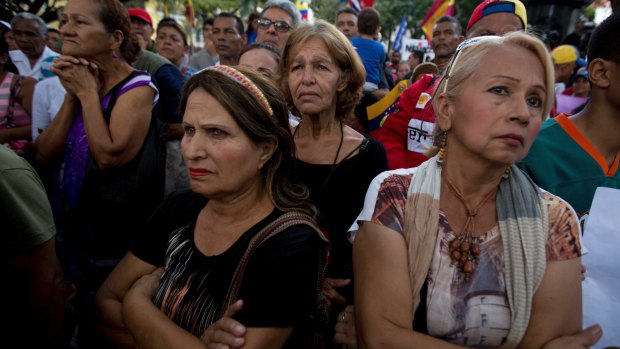 Supporters of Venezuelan President Nicolas Maduro listen to a pro-government lawmakers during a rally in Caracas this week.