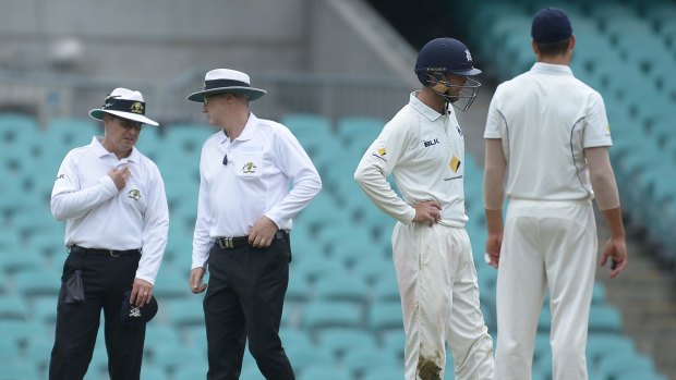 Controversial game: Umpires discuss the match conditions during the Sheffield Shield match between New South Wales and Victoria at the Sydney Cricket Ground.