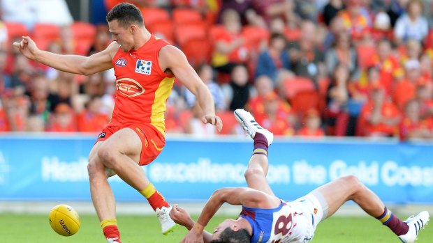 Tom Rockliff of the Lions is knocked out after colliding with Steven May.