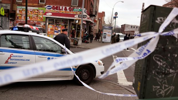 A police officer stands guard near where two NYPD officers were shot.