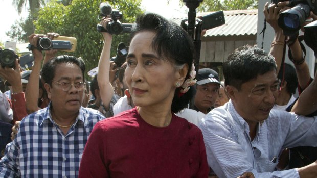 Aung San Suu Kyi visits a polling station on the outskirts of Yangon on Sunday.