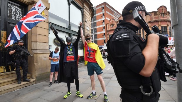 Two men dressed as Batman and Robin wave a Union flag close to the starting line of the Great Manchester Run on Sunday.