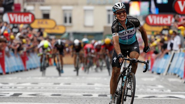 Tony Martin of Germany riding for Etixx-QuickStep celebrates ahead of a charging peloton as he wins stage four of the Tour de France in Cambrai, France.