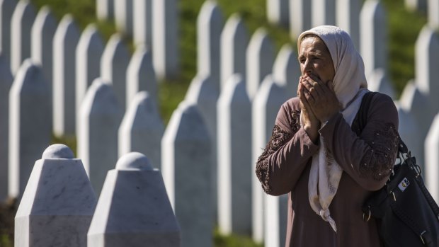 A woman reacts at the Potocari cemetery and memorial near Srebrenica on Friday, ahead of the burial of 136 newly-identified victims of the Srebrenica massacre.