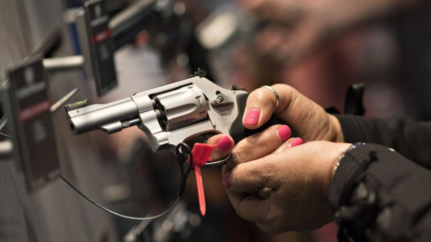 Potential customers try out handguns at an annual NRA event in Tennessee in April. 
