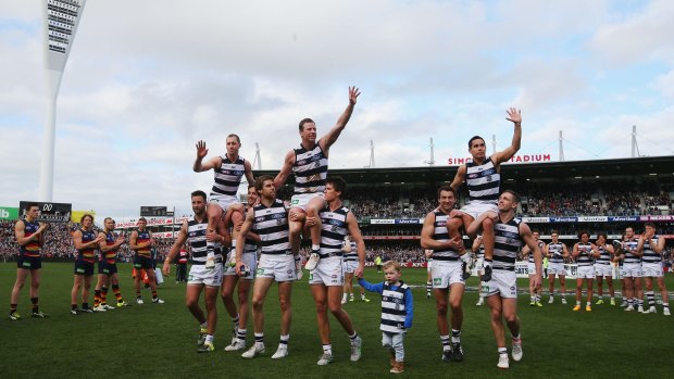Fond farewell:  James Kelly (L) is carried off by Jimmy Bartel and Harry Taylor, Steve Johnson of the Cats (C) by Tom Lonergan (L) and Andrew Mackie and Mathew Stokes is carried off by Corey Enright and Joel Selwood (R) after playing their last game for Geelong.