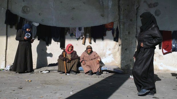 Displaced Syrians gather at a shelter in the village of Jibreen, south of Aleppo, on Monday.