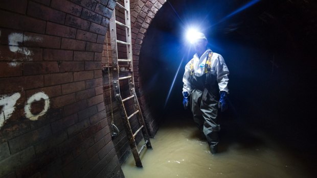 A sewer worker in the Northern Outfall Sewer in London. Technology developed in Queensland could make this man's job much more pleasant.