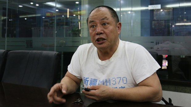 Wen Wancheng's T-shirt is a poignant reminder of his 34-year-old son: "Pray for the safe return of MH370," it says.