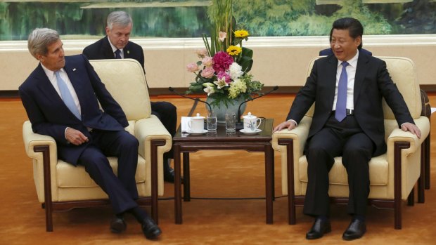 U.S. Secretary of State John Kerry (L) sits on a chair for the meeting with Chinese President Xi Jinping at the Great Hall of the People in Beijing, China, May 17, 2015.  REUTERS/Kim Kyung-Hoon