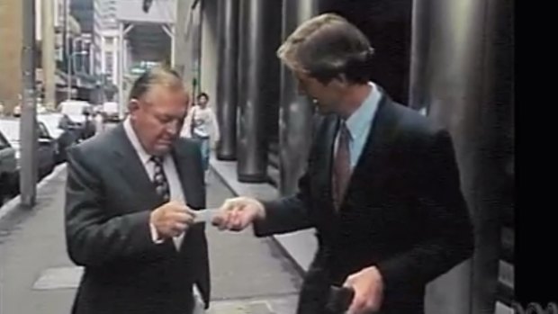 The ABC's Paul Barry confronts Alan Bond in an incident that infamously led to Bond stomping on Barry's business card.