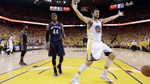 Andrew Bogut celebrates dunking one home past Dante Cunningham.