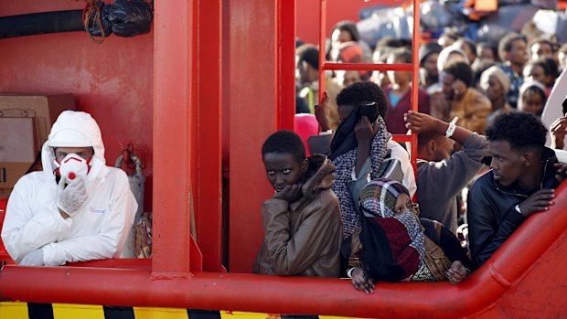 Illegal migrants wait to disembark in southern Italy earlier this month. 