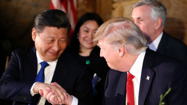 Donald Trump and Xi Jinping shake hands during a dinner at Mar-a-Lago.