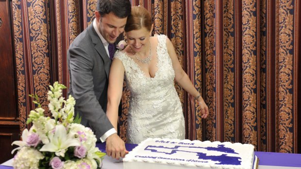 Australian Ruth Greenwood and her husband Nick cut their wedding cake in the shape of the electoral map of Winsconsin.