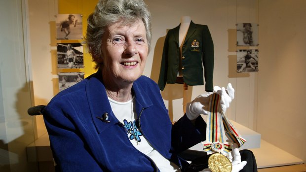 Betty Cuthbert with her 1964 gold medal and blazer at the Powerhouse Museum where memorabilia from her career were part of an exhibition in 2003. 