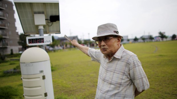 Atsushi Hoshino, a 87-year-old Hiroshima atomic bombing survivor, former college professor and ex-president of Fukushima University, beside a radiation meter, near his home in Fukushima.