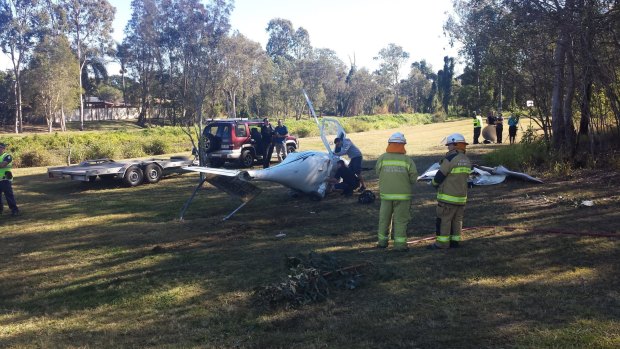 Investigators at the scene of a light plane crash in Runcorn, south of Brisbane.