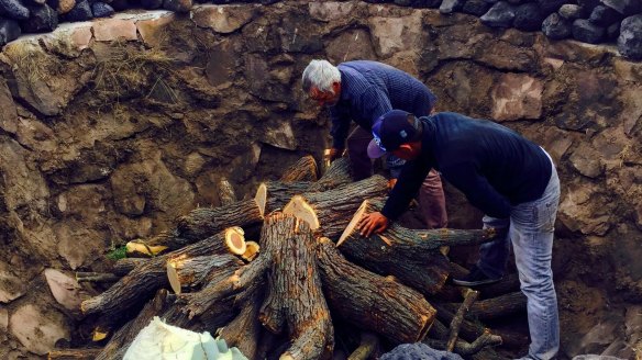 Mezcaleros from the Burrito Fiestero distillery prepare a fire pit to cook agave hearts, before they are crushed, fermented and distilled.