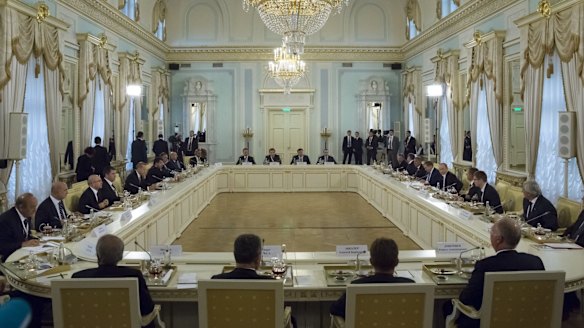 Russian President Vladimir Putin, fifth right, and Turkish President Recep Tayyip Erdogan, fifth left, attend a meeting with Turkish and Russian businessmen in the Konstantin palace.