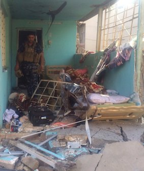 An Iraqi soldier inspects one of the damaged buildings after clashes between Iraqi security forces and members of the Islamic state in the city of Kirkuk.