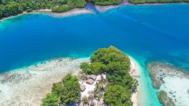 The route to Bougainville takes you over the brilliant blue of the Pacific, dotted with cayes and atolls.