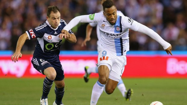 Leigh Broxham of the Victory and Harry Novillo of City compete for the ball during the A-League semi-final on Friday.