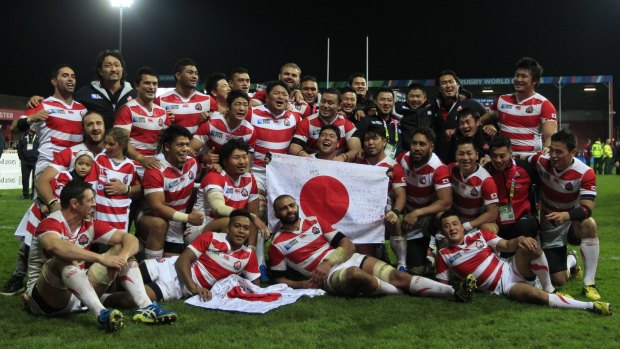 Celebrations: Japan players pose for the cameras after the Rugby World Cup Pool B match between USA and Japan at Gloucester.