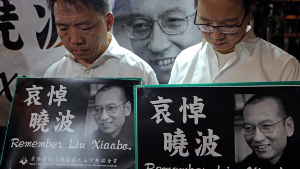 Protesters mourn jailed Liu Xiaobo during a demonstration in Hong Kong.