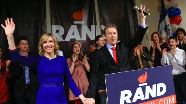 Struggled to attract votes in Iowa ... Senator Rand Paul and his wife Kelley wave to supporters at a caucus night rally in Des Moines, Iowa on Monday.