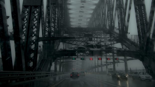 Heavy rain and grey skies on the Sydney Harbour Bridge.