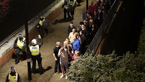 People are lead to safety away from London Bridge.