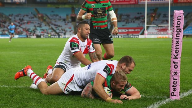 Many vacant seats: Rabbitohs winger Aaron Gray scores against the Dragons on Monday night.