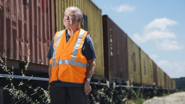 Corporate services manager of the Canberra Rail Museum, Bruce Blain with freight being loaded to leave Canberra by rail. 