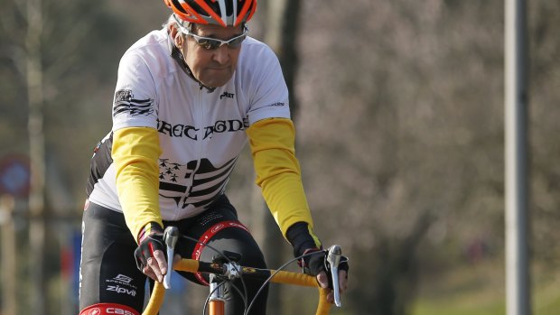 John Kerry, pictured in March, riding his bicycle along the shore of Lake Geneva.