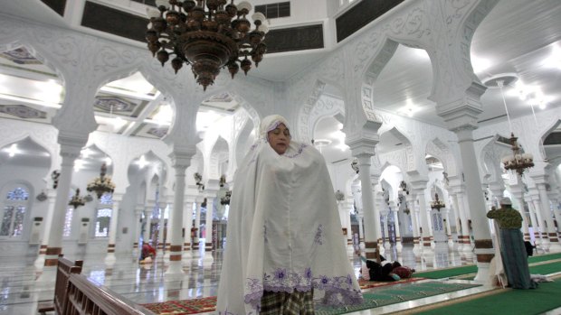 A woman prays in  Baiturrahman Grand Mosque in Banda Aceh on Friday. 